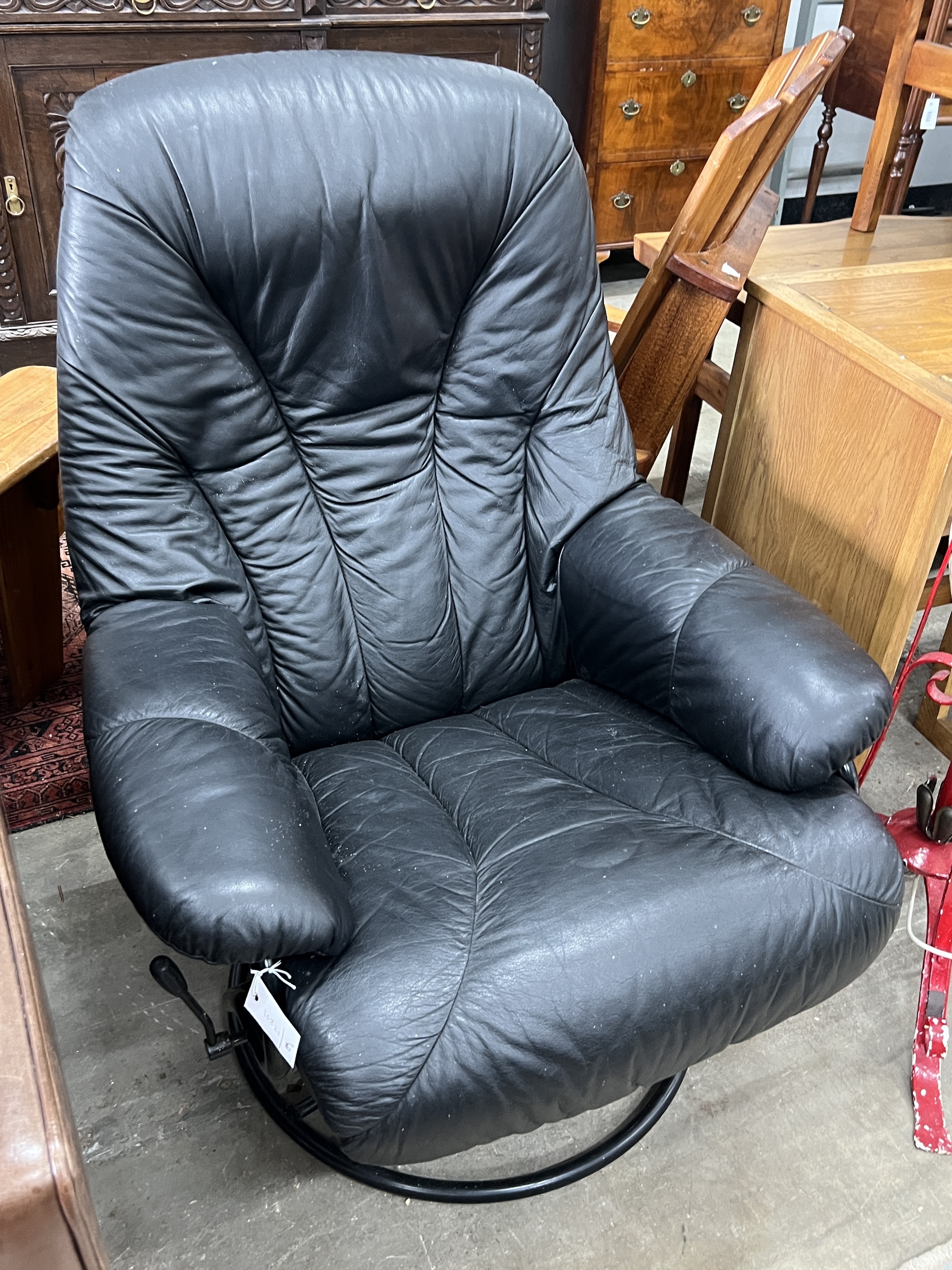 A mid century Scandinavian black leather reclining swivel armchair, width 74cm, depth 78cm, height 96cm